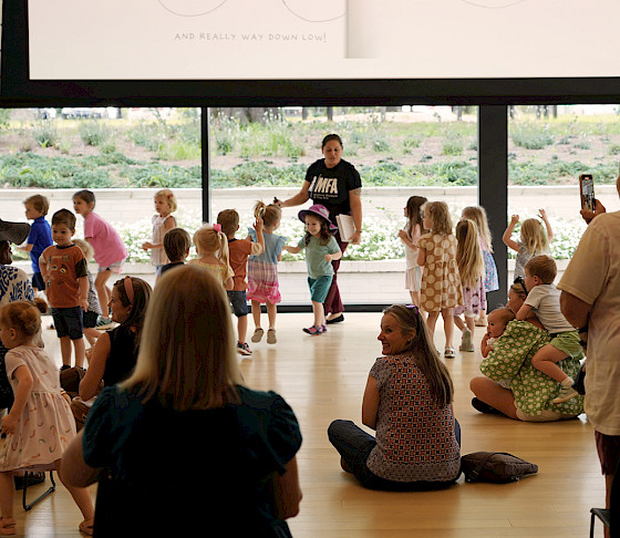 Photo of children and their parents interacting during a free program at the Arkansas Museum of Fine Arts.