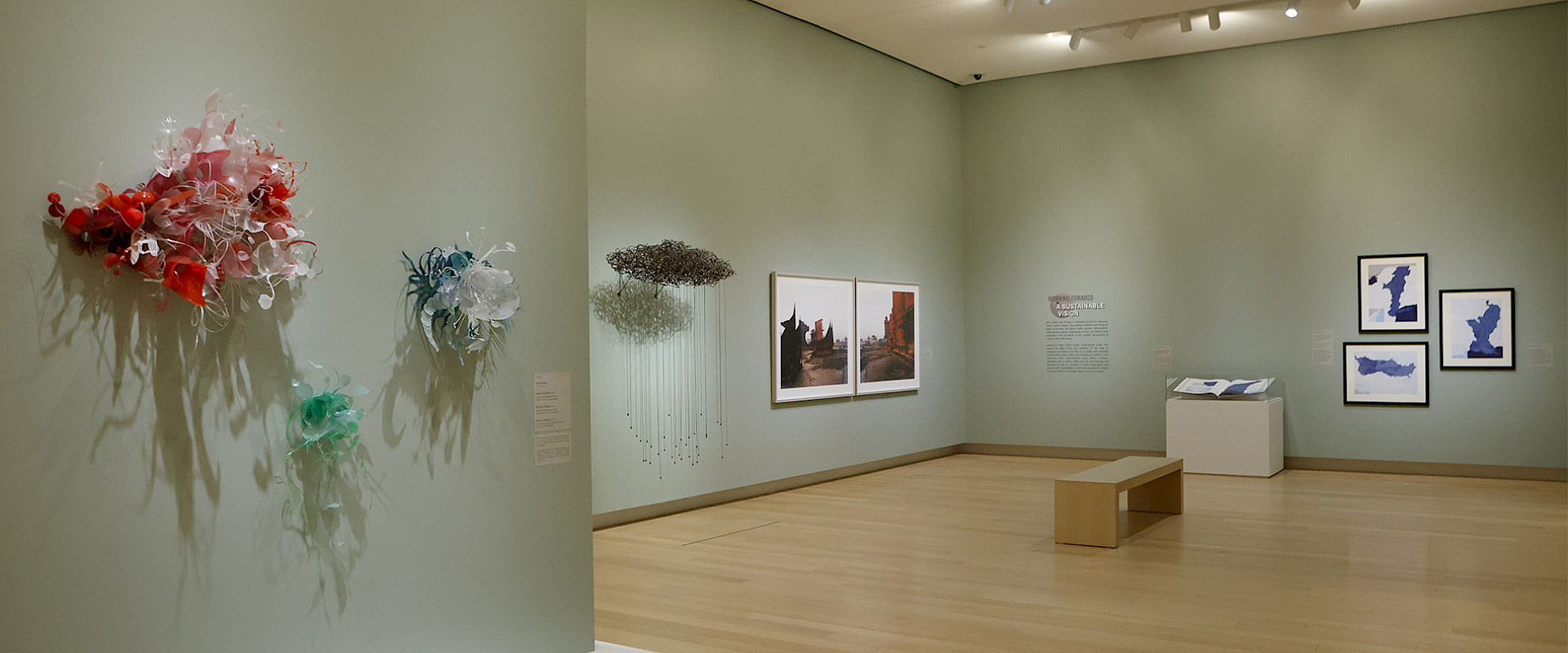 Photo of contemporary sculptures hanging in an art gallery.