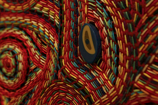 Close up detail photo of multi-colored fiber artwork.