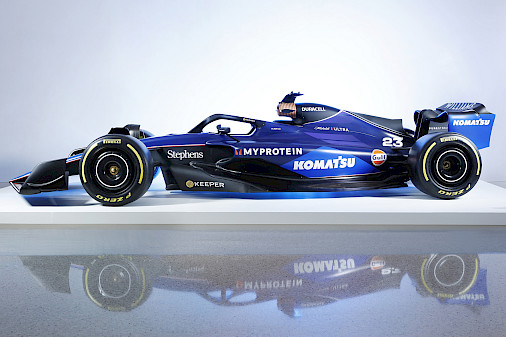 Photo of a Formula 1 racecar on a white platform in the Atrium at the Arkansas Museum of Fine Arts.