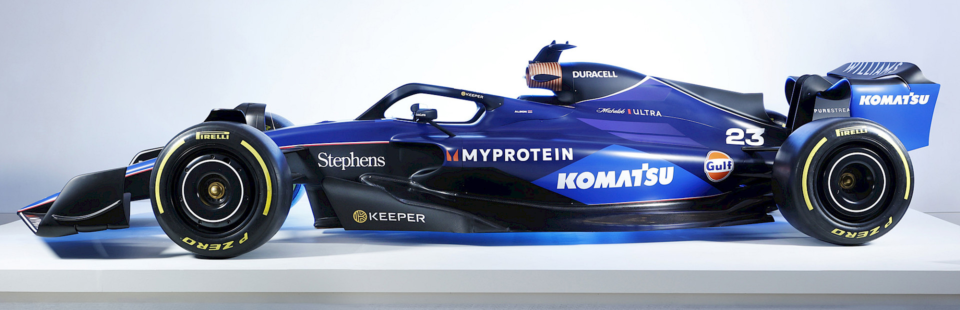 Photo of a Formula 1 racecar on a white platform in the Atrium at the Arkansas Museum of Fine Arts.