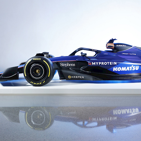 Photo of a Formula 1 racecar on a white platform in the Atrium at the Arkansas Museum of Fine Arts.