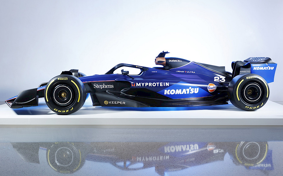 Photo of a Formula 1 racecar on a white platform in the Atrium at the Arkansas Museum of Fine Arts.