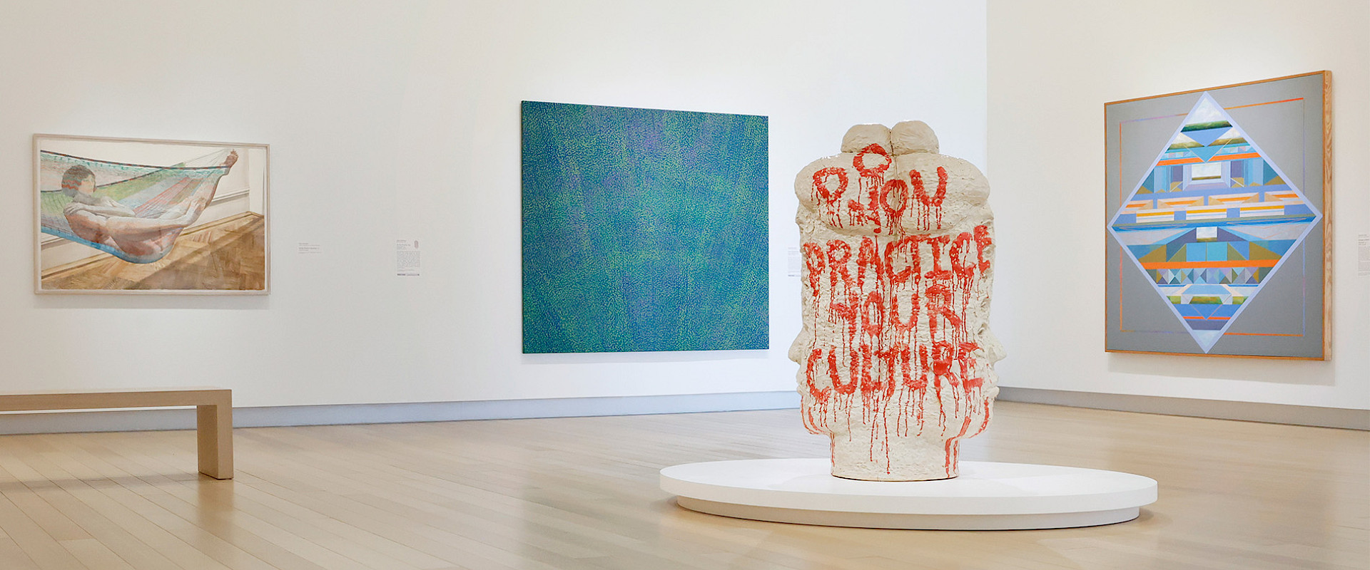 Photo of a woman and a man looking at contemporary art in an art gallery.