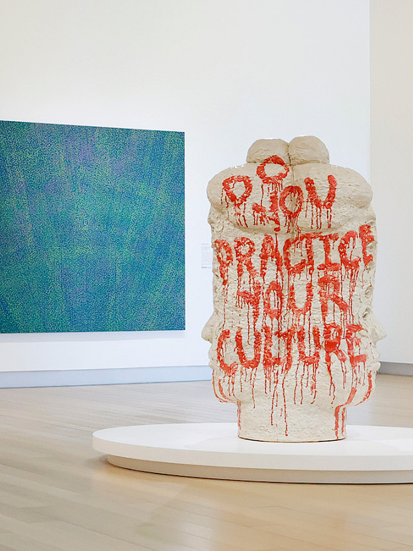 Photo of a woman and a man looking at contemporary art in an art gallery.