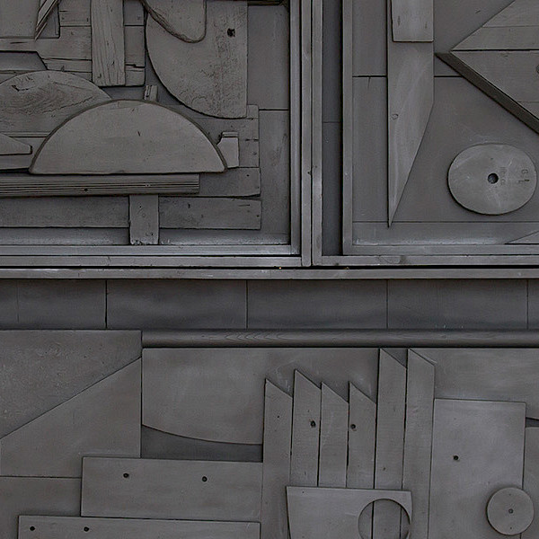 Photo of a black found object sculpture by Louise Nevelson.