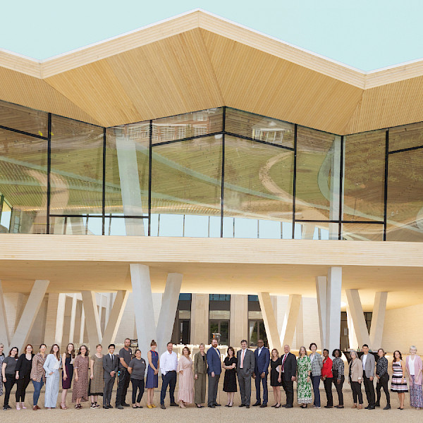 Photo of a large group of AMFA staff members standing in front of the North Entrance to the new Museum.