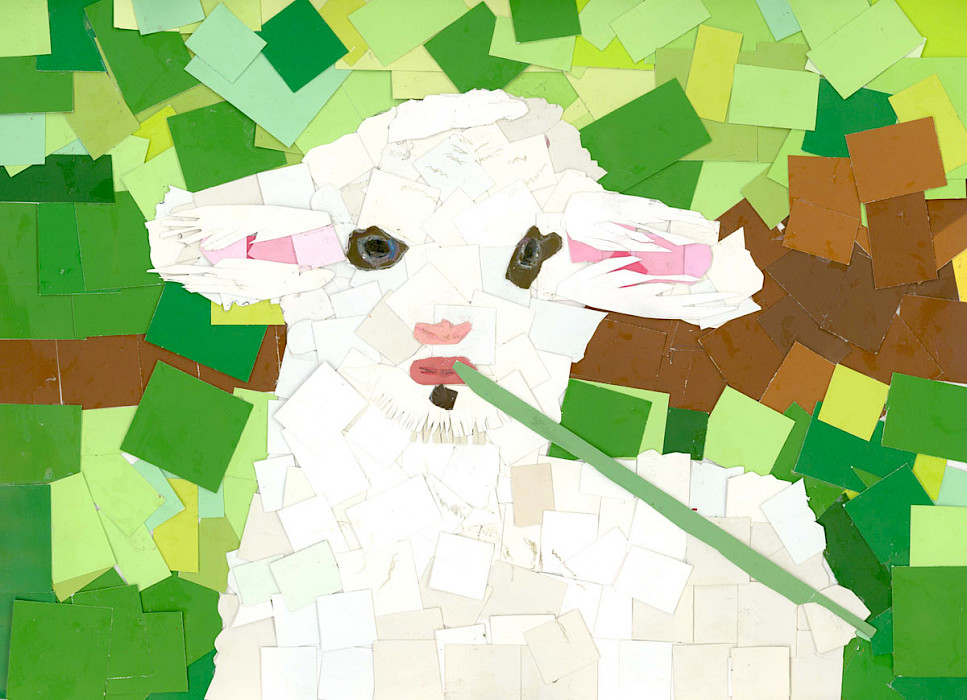 Photo of a cut paper artwork depicting a lamb eating a blade of grass on a green background.