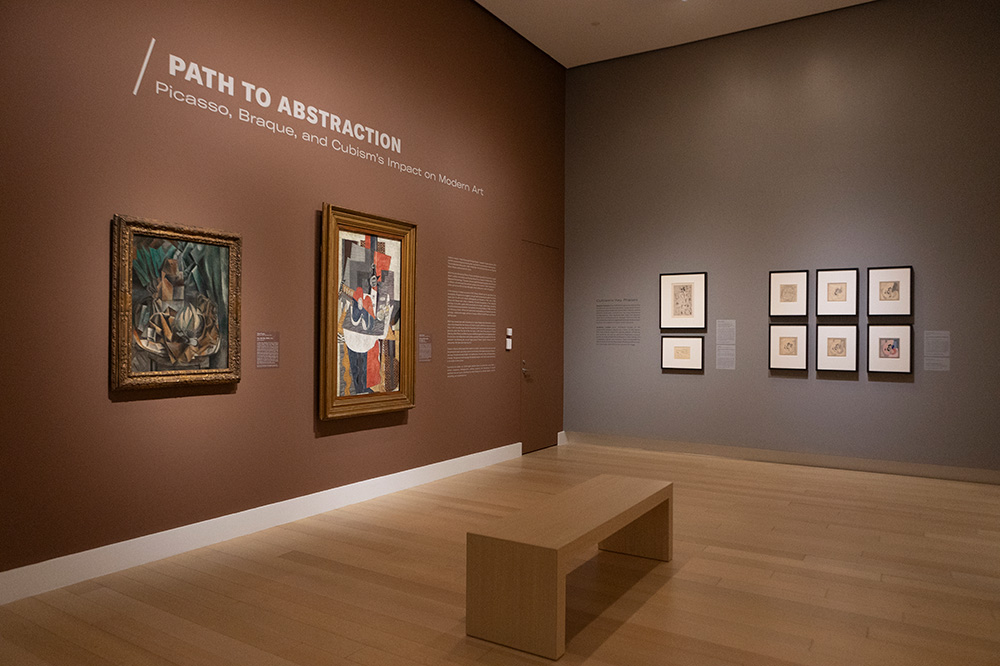 Photo of an art gallery at the Arkansas Museum of Fine Arts displaying framed Cubist paintings.