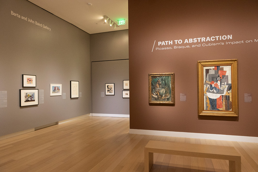Photo of an art gallery at the Arkansas Museum of Fine Arts displaying framed Cubist paintings.