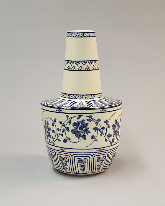 Photo of a ceramic vase painted with a blue pattern.
