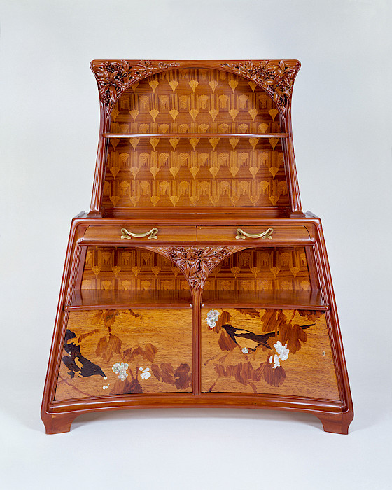 Photo of a carved wood console table with decorative inlays.