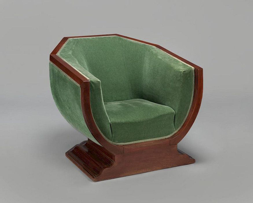 Photo of a green velvet chair with mahogany trim.