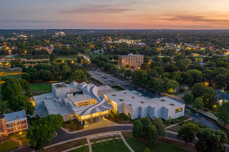 Aerial photo of the Arkansas Museum of Fine Arts taken at sunset.