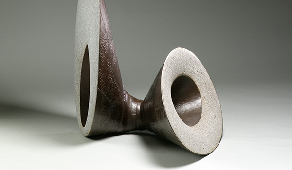 Detail photo of a rounded abstract sculpture made from forged steel and concrete by Rick Smith.