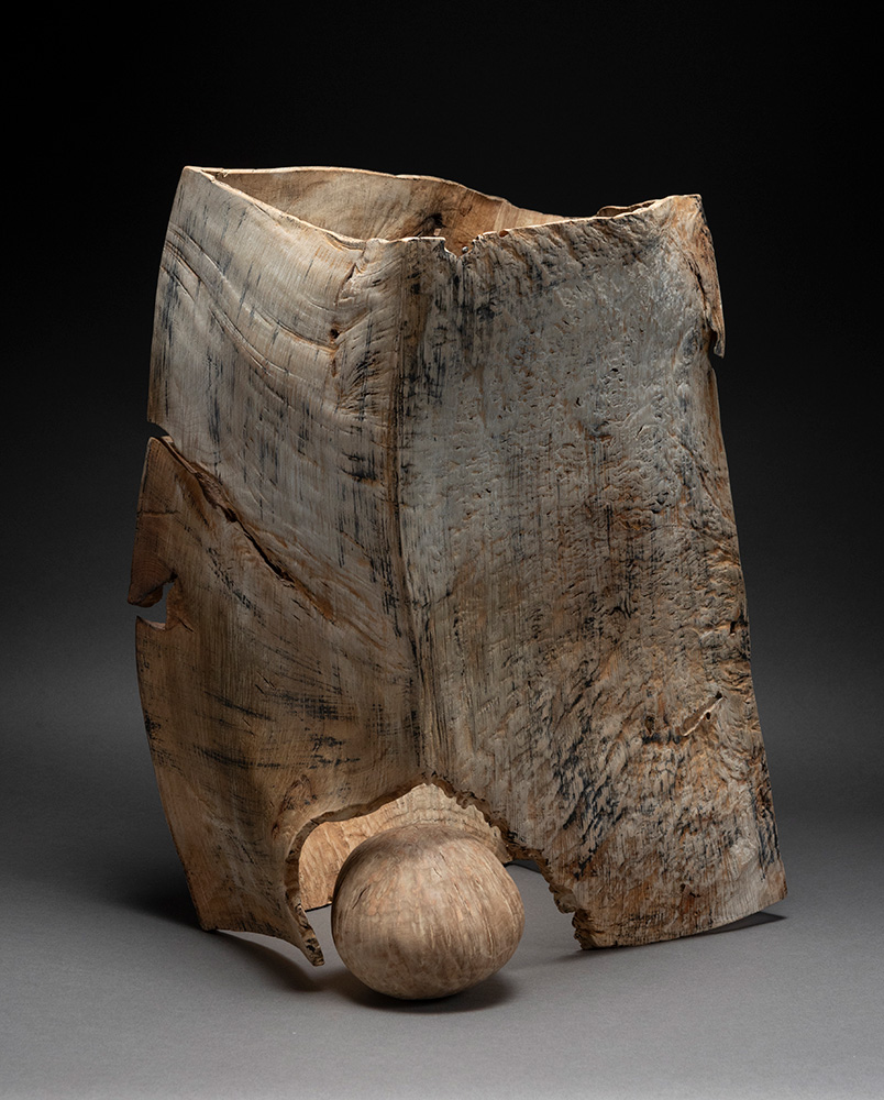 Photo of an abstract wooden sculpture by Michael Peterson.