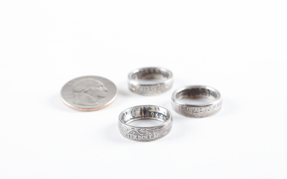 Photo of three coin rings sitting next to a quarter on a white background.