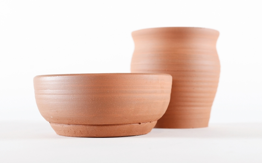 Photo of two handmade, unglazed clay pots.