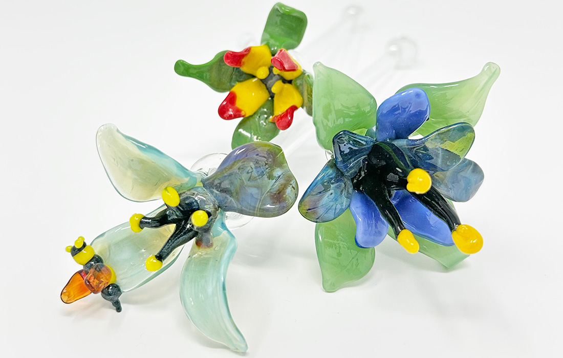 Photo of three small handmade glass flowers.