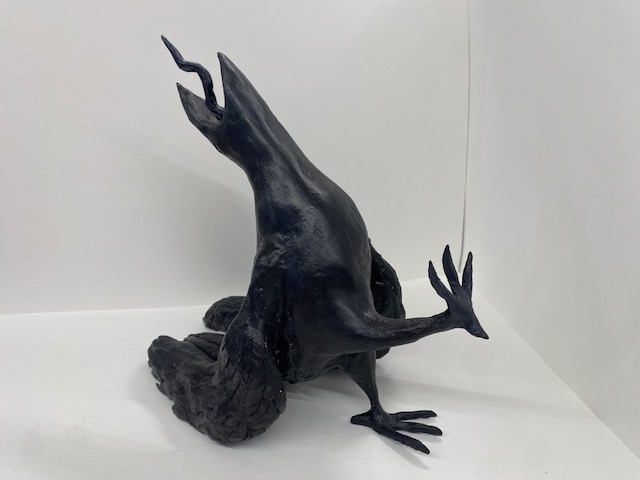 Photo of small black sculpture in the shape of a sick bird.