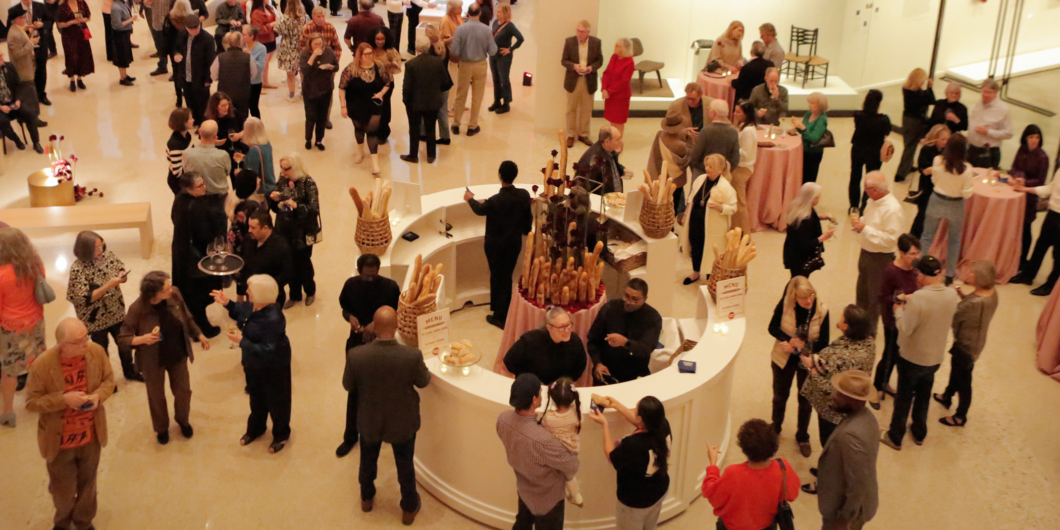 Overhead photo of a crowd of people at a party in the Atrium at the Arkansas Museum of Fine Arts.