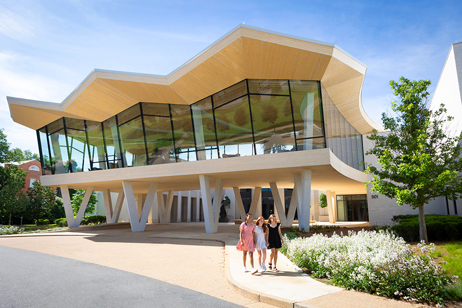Photo of three girls walking near the Courtyard Entrance to the Arkansas Museum of Fine Arts.