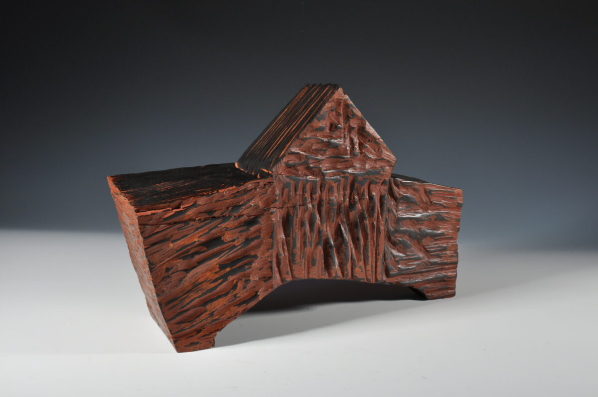 Photo of an abstract wooden sculpture.