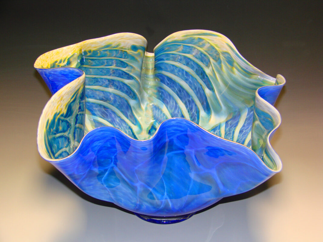 Photo of a tall fluted blue glass bowl.