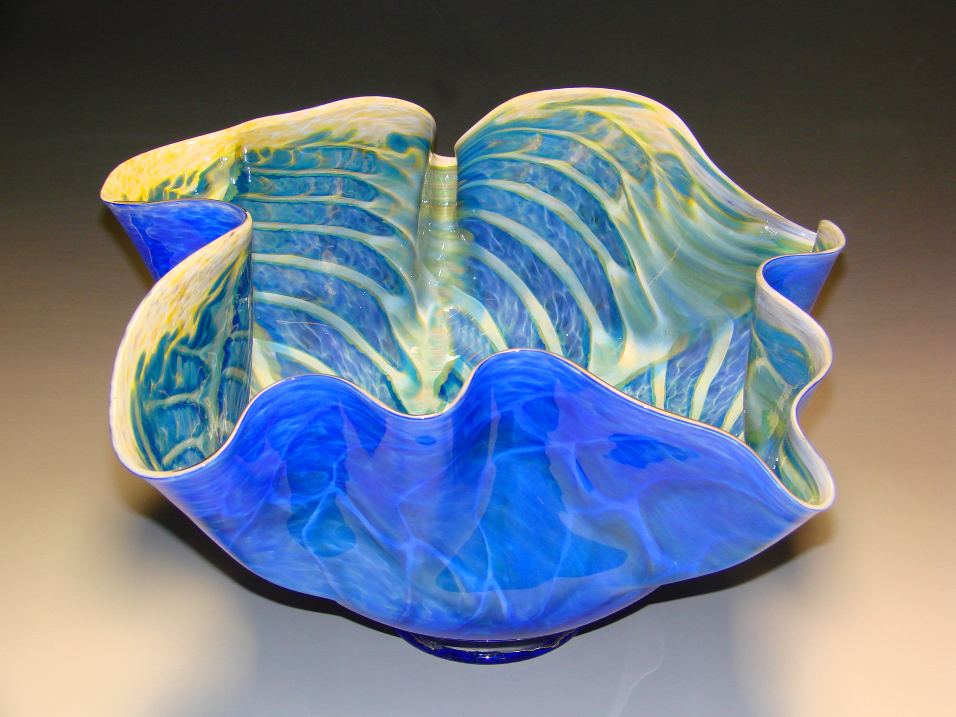 Photo of a tall fluted blue glass bowl.